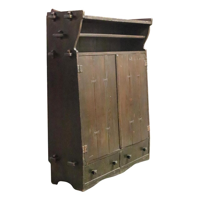 Solid oak Arts & Crafts storage cabinet in dark tones. It features fantastic joinery detailing, including butterfly joints...