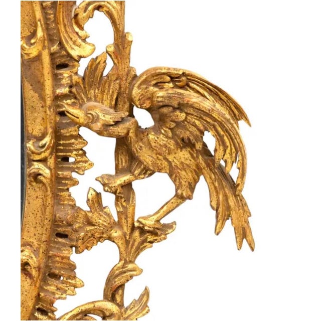 Chinese Chippendale Style Giltwood Pagoda Wall Mirror. The carved oval frame is crowned by an elegant pagoda crest with...