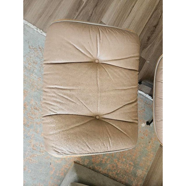 Vintage C.F.A. Eames-style lounge chair and matching ottoman. This piece features bent plywood shells paired with the...