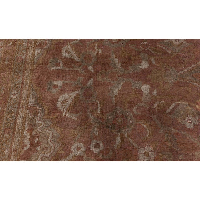 This oversized antique Amritsar carpet, woven around 1900, is a remarkable testament to the refined artistry of Indian rug...