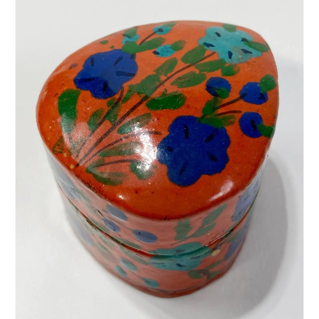 Vintage rich rust colored hand-painted lacquered box with bouquet of vibrant blue flowers to top lid. Natural age wear....