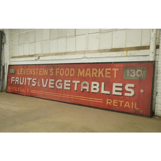 Reclaimed movie set sign made of aluminum in red, yellow, white, green, and black colors. The sign reads "130,...