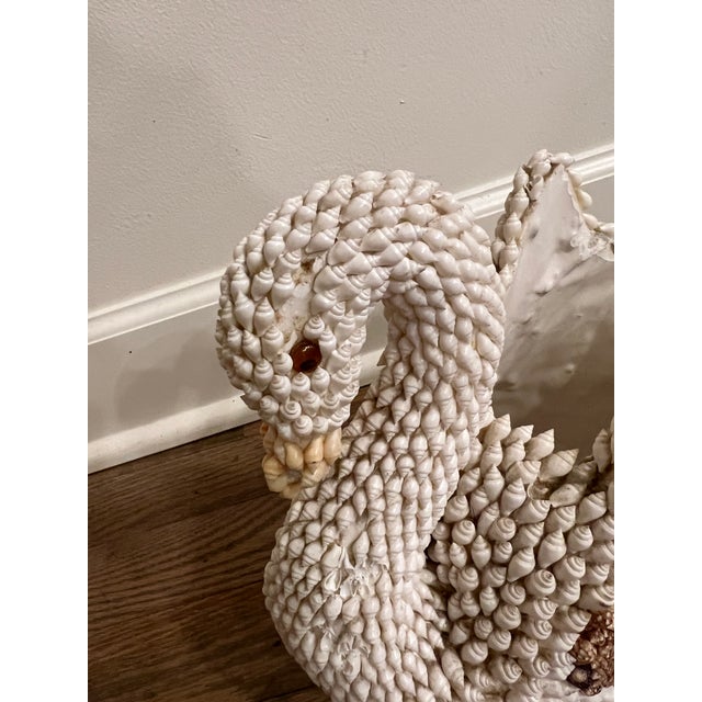 Gorgeous ceramic swan encrusted in white and brown seashells.