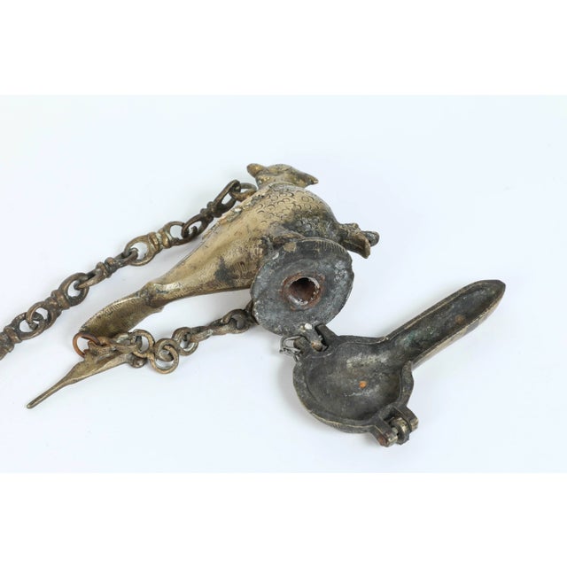 Antique hanging cast bronze oil lamp in the shape of a beautiful mythical bird peacock figure with hanger chain. The body...