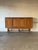 This spacious storage piece features elegant paneled cabinet doors and an open base with turned supports. Crafted by...