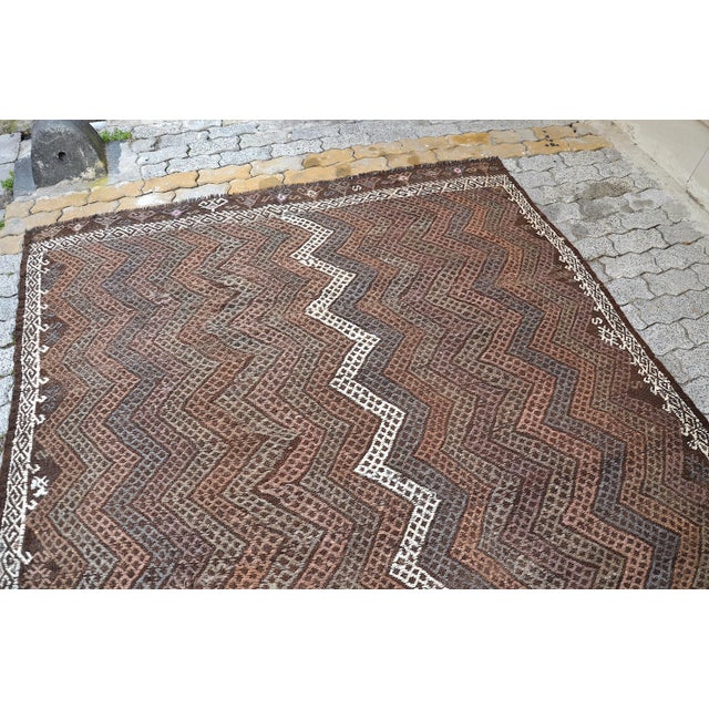 This is a vintage Turkish Anatolian kilim rug from the 1960s. The piece was hand-woven.