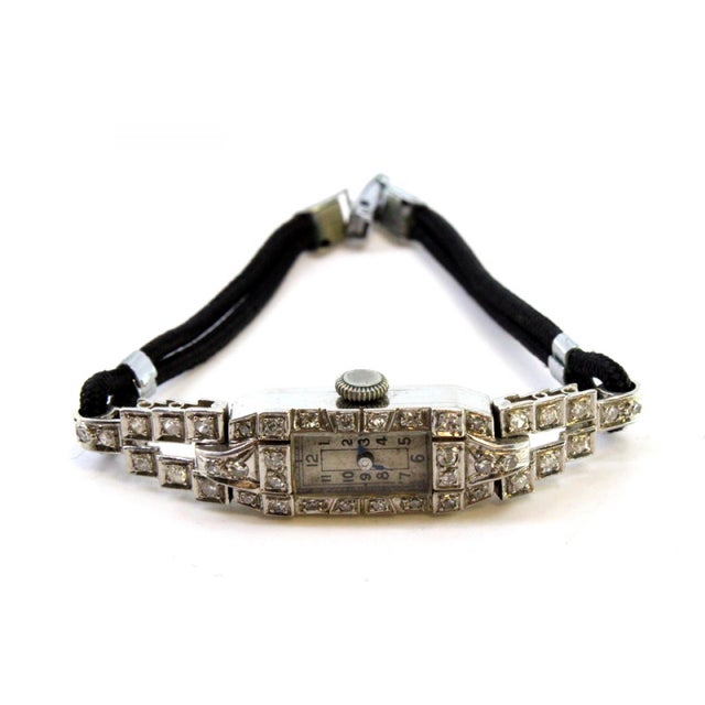 Platinum watch with brilliant-cut diamonds and articulated bracelet with cordonèe. Metal: Platinum. Origin: French. Brand:...