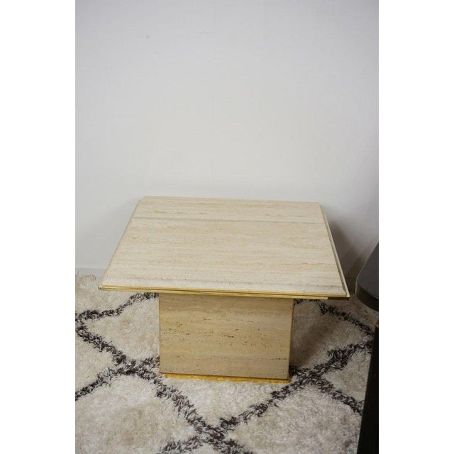 You will be seduced by the charm, elegance and presence of this travertine and brass coffee table in the Hollywood Regency...