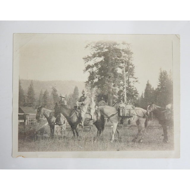 Early 20th century sepia tone snapshot photograph of family heading out with horses and packs. Unframed, small corner loss...