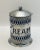 A vintage hammer finish silver plate cream jar with blue plastic insert and spoon holder on the side.