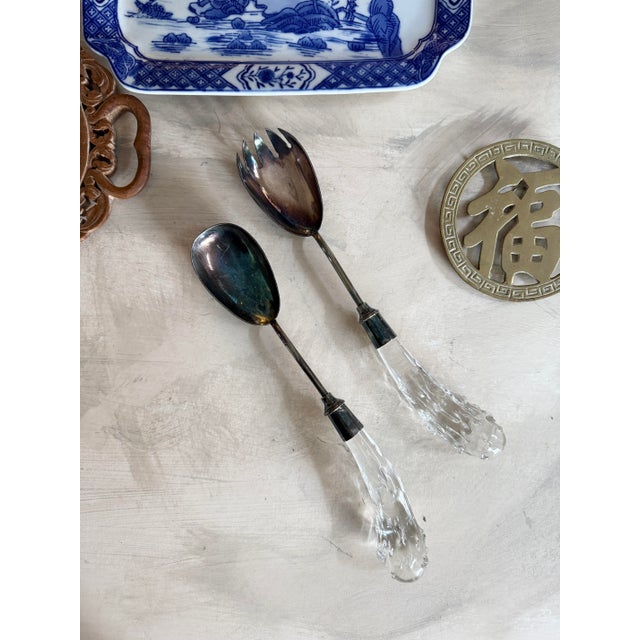 Beautiful vintage serving set featuring a pierced salad fork and matching serving spoon with sculptural clear art lucite...