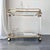 Vintage serving/bar cart in the style of the Italian Hollywood Regency of the 1970s–1980s, featuring decorative Medici...