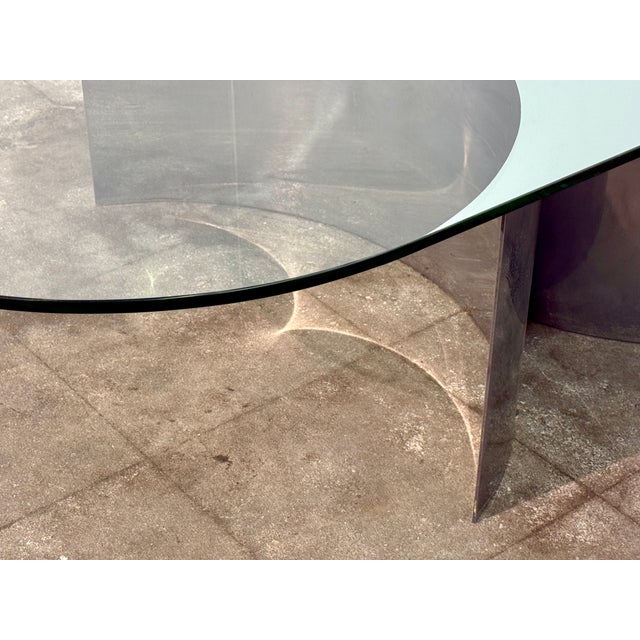Sculptural Italian coffee table from the 1970s by Giuseppe Raimondi Mod. 3102, featuring a thick oval glass top supported...