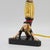 Rare Find! Accent lamp with an Asian acrobat performing a handstand on a black triangular base while balancing the light...