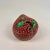 A delightful porcelain lychee fruit trinket box with a colorful green interior.