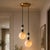 Add a warm sculptural presence to your interior with this handcrafted brass 2-light pendant featuring natural alabaster...
