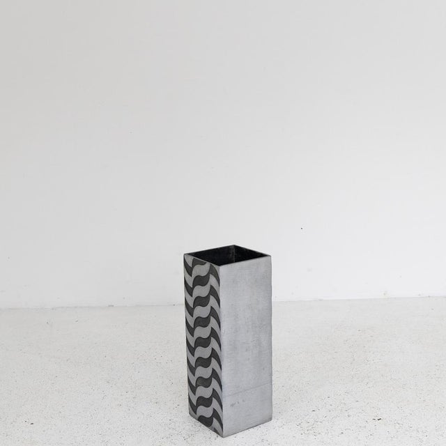 A sculptural umbrella stand created by Lorenzo Burchiellaro in the 1970s. The work features an aluminum structure with...