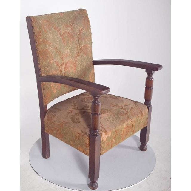 Low armchair with upholstered back and seat. The backrest and seat are generously proportioned, comfortably cradling the...