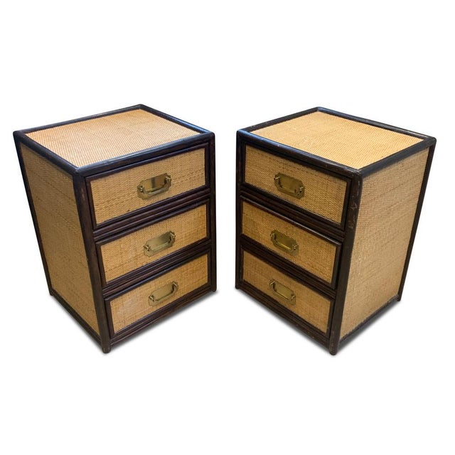 A pair of mid-century organic rattan three drawer nightstands. ebonised wood, frames the chest and the glazed top finishes...