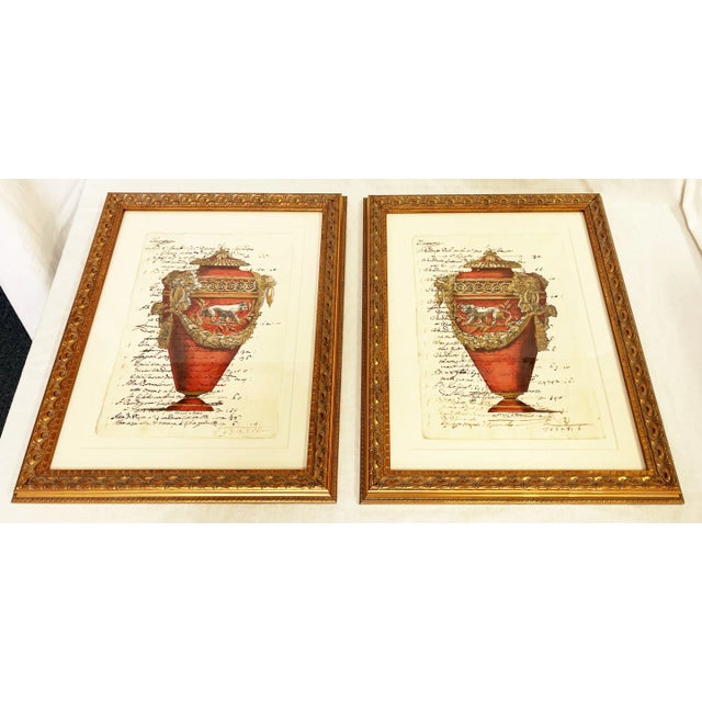 Sophisticated pair of reproduction hand colored etchings. Each depicts a Neoclassical design with a lion or lioness on red...