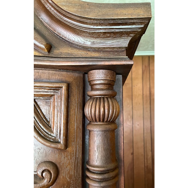 A monumental single-piece cabinet in the Spanish Baroque Revival style. The cabinet is built on a solid hardwood frame...
