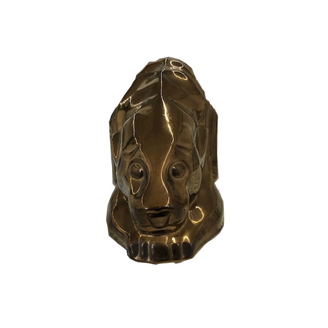 The dark gold/bronze lion is a lacquered ceramic statue that will add a touch of glam to any book shelf.