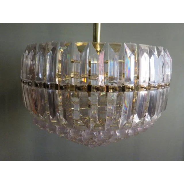 Hollywood Regency large round pendant with acrylic slats and cut balls. The frame is made of gilded metal and provided of...