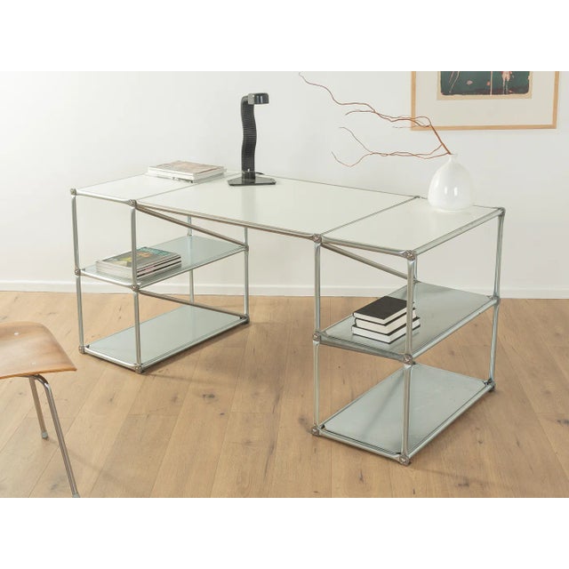 Classic desk from System 180 from the 1990s. High-quality frame made of stainless steel tubes with sheet metal shelves and...
