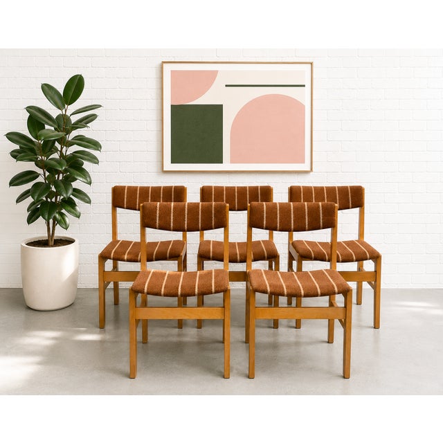 Set of five Mid Century Modern Dining Chairs featuring solid oak frames and original textured wool upholstery in a warm...
