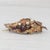 This lovely antique brooch features finely detailed floral work along the body of a leaf design. This piece comes with an...