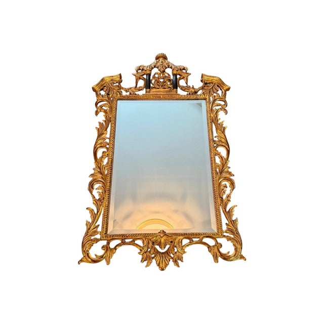 A striking antique giltwood wall mirror featuring an exceptionally ornate hand-carved openwork frame with scrolling...