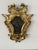 Pair of Italian giltwood mirrors, late 18th/ early 19th century in the Baroque taste. The shield-form mirrors with broken-...