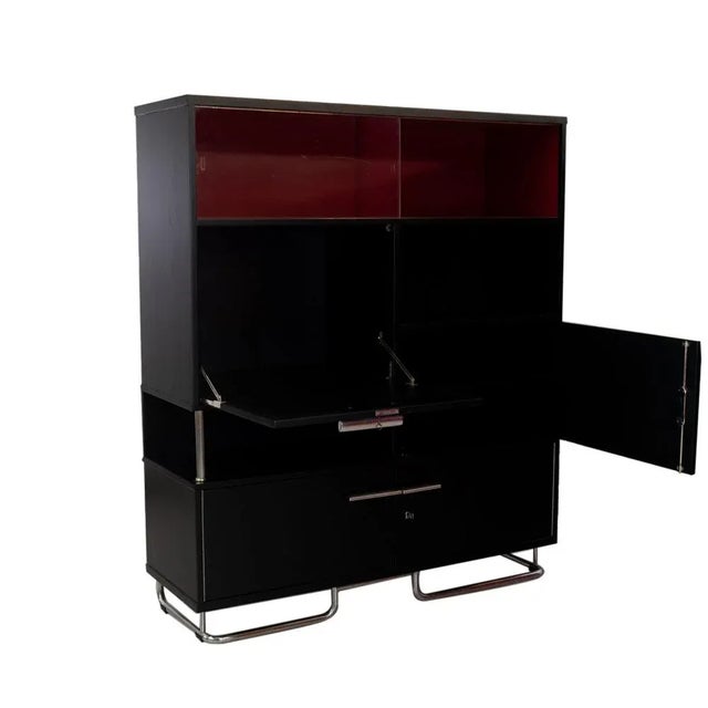 This Bauhaus Kabinett was built from veneered carpenter. The surface is painted by silk matt. The upper compartment with...