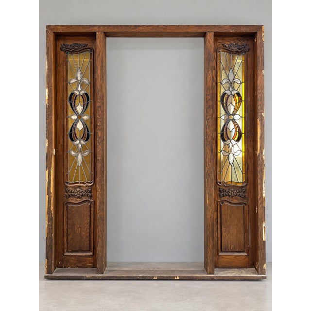 Carved oak entry door set removed from a 1981-built Brentwood (Los Angeles) home. A single entry door with two leaded...