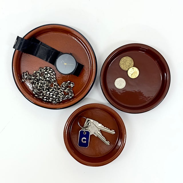 Clay ceramic dishes, group of 3. A group of terracotta and ink-blue ceramic clay dishes in a variety of sizes and...