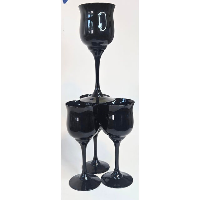 Sleek, fluid black in an intensely opaque black drips down goblets made for drama. The slightly bell topped lips and...