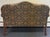 Elegant vintage settee featuring a beautifully shaped camelback silhouette, classic rolled arms, and richly patterned...