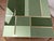 This square coffee table features green Murano glass of different shades and elegant brass bands, embodying the Mid-...