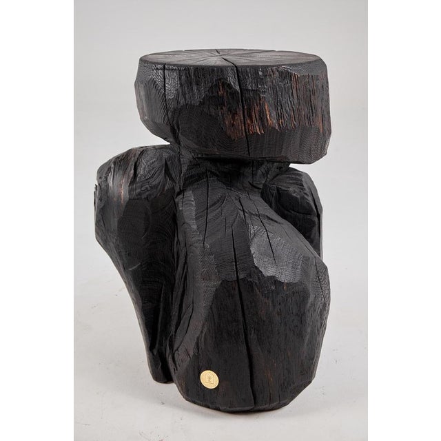 Chainsaw carved side table. Carved from a single piece of burnt oak wood and protected with the highest quality oils,...