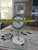 This mid-century modern style sunburst table clock features a striking gold-tone metal frame with radiating rods and a...