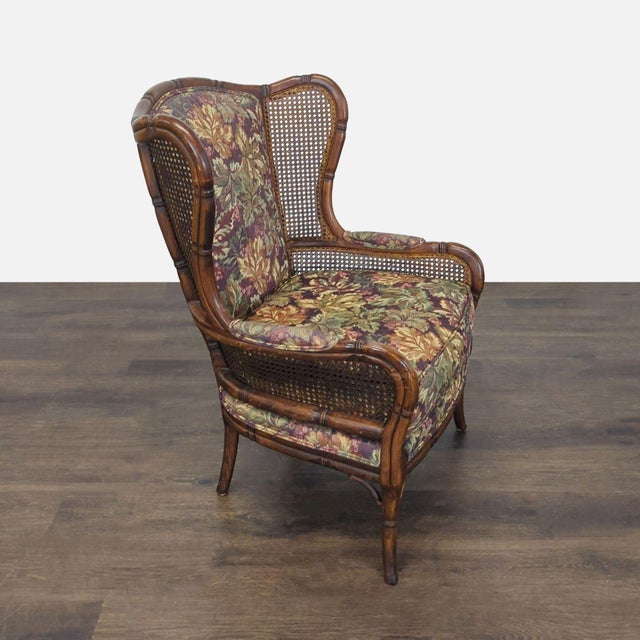 This Ethan Allen lounge chair features a cozy floral upholstery and elegant cane sides. The wood frame is sturdy with a...