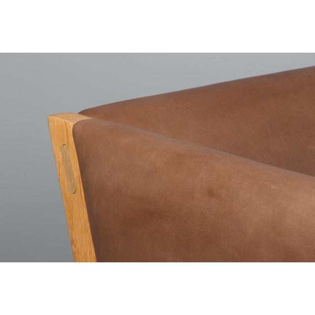 Hans J. Wegner three-seat sofa, new upholstered with tobacco full grain aniline leather. Frame in solid soap treated oak....