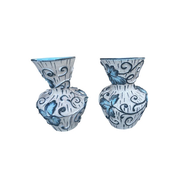 Beautiful vintage ceramic vase pair featuring a distinctive sculptural silhouette, vibrant turquoise-blue glazed...