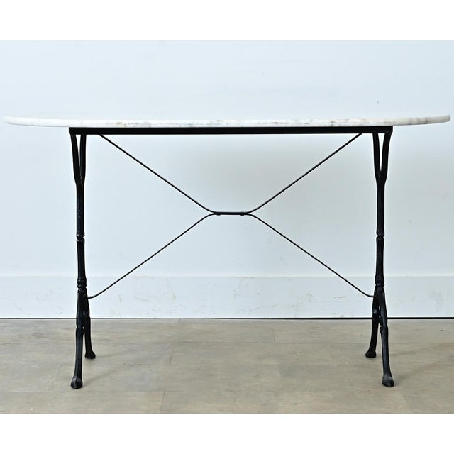 An exceptional early 20th Century capsule-shaped marble top French bistro table with fabulous design elements throughout....