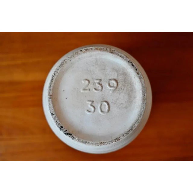 with its geometric decor, this cylindrical vase is typical of West German productions of the 60s. The decor consists of a...