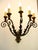 A pair of 19th-century wrought iron sconces, five curved arms decorated with leafy elements and ending with bobeches, a...