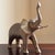 Offering gorgeous mid-20th century brass elephant sculpture with lovely aged patina. With long trunk pointed upwards, this...