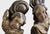 A beautifully expressive pair of hand-carved wooden cherubs, originating from Germany. Each figure emerges from swirling...