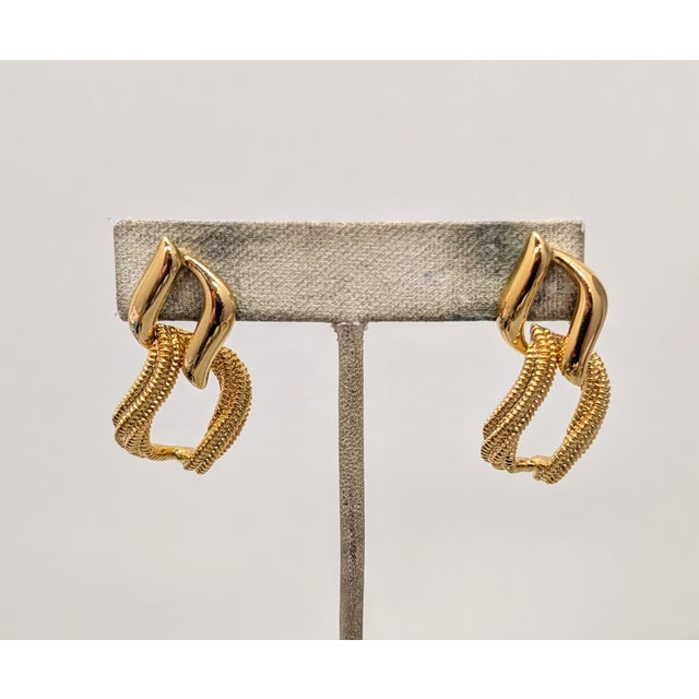 1992 goldtone smooth openwork top with textured openwork link drop pierced push back earrings. Marked "NAPIER©" on the...