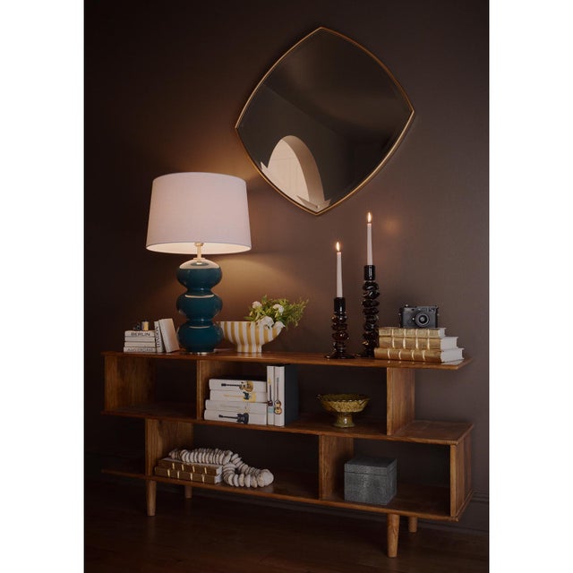 Defined by beveled glass and slender frame the Gem Mirror captures light along its edges, creating a subtle gem-like...